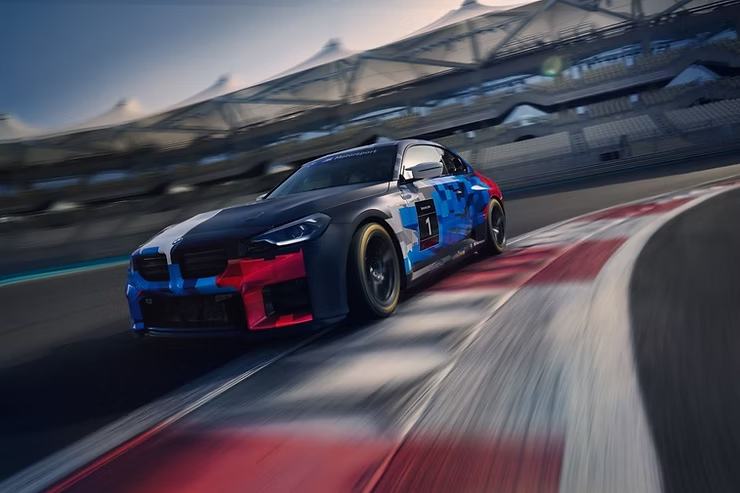 BMW M2 Racing on track at night under the floodlights