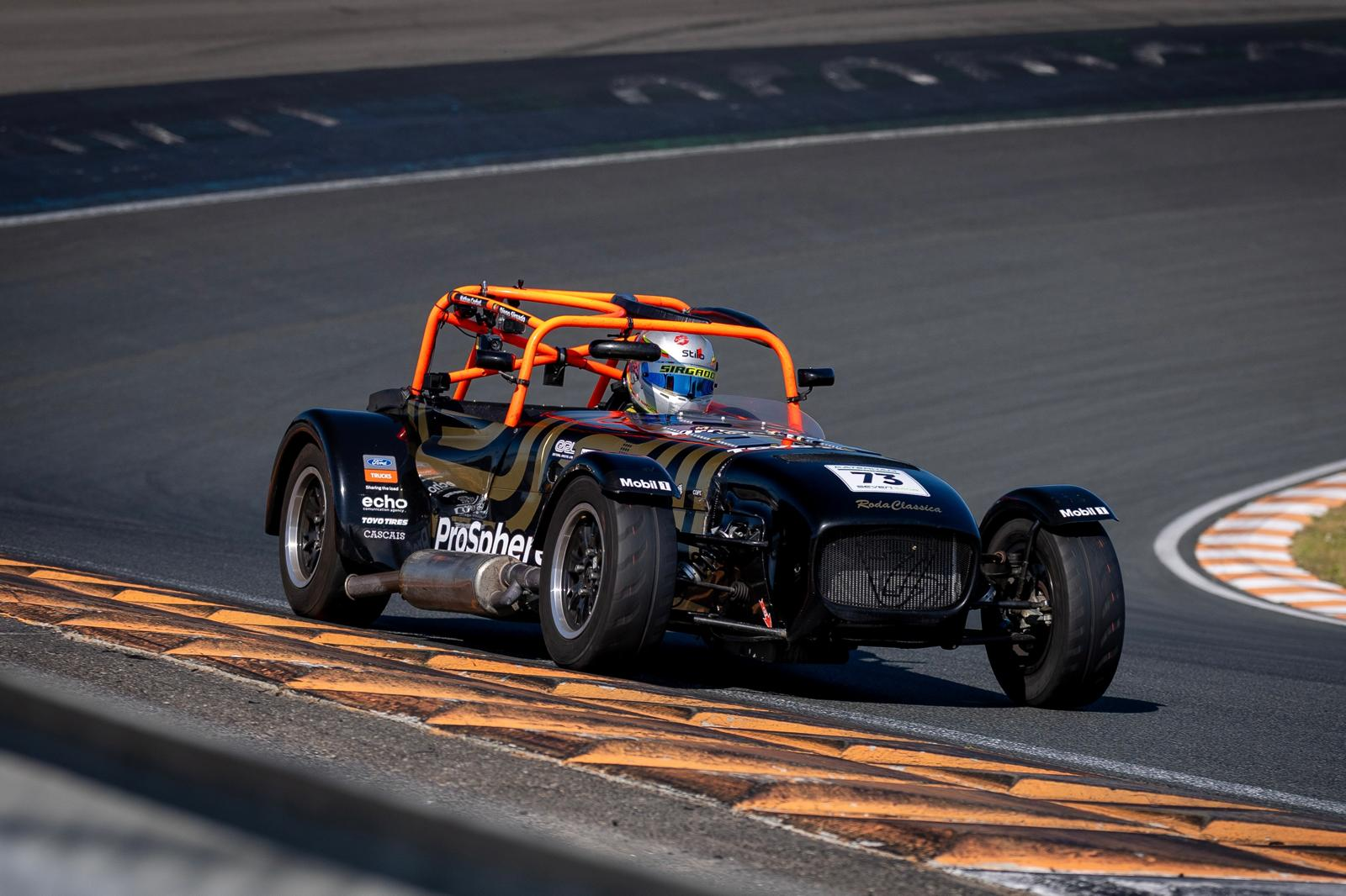 Diego Sirgado driving a Caterham on track with a passenger for a sponsor hot lap experience